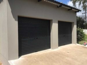 2 black garage doors with concrete walls