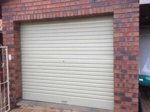 white garage door with a brick wall